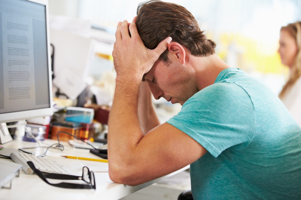 Man experiencing poor mental health due to work related stress